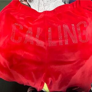 Red velvet like pants “Calling” on the back with pockets
